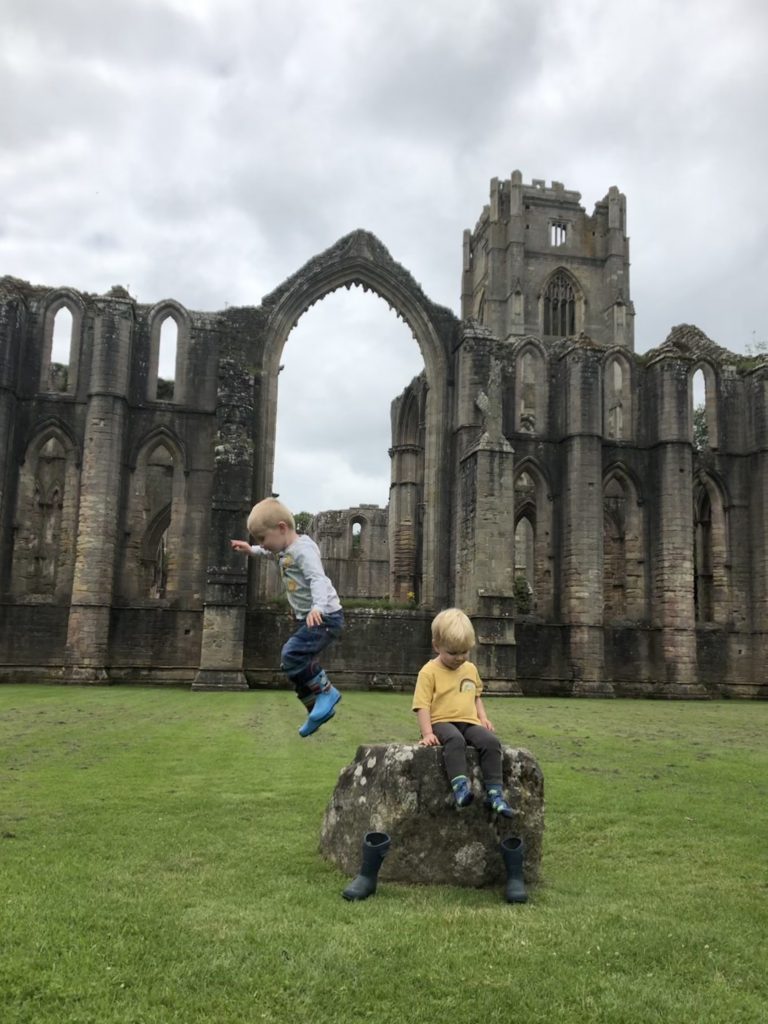 jumping in front of fountains abbey